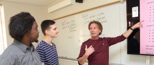 Instructor discussing concepts with students in class.
