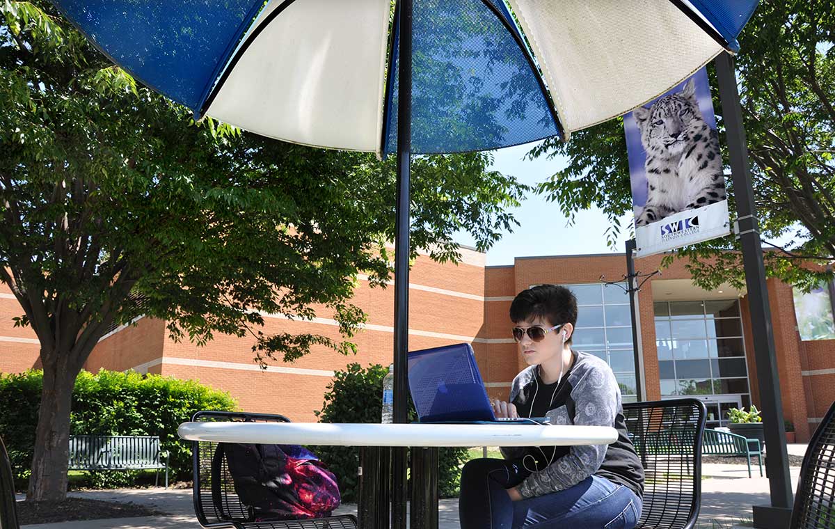 SWIC Student studying outside