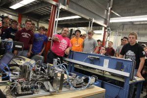 Lou Marino shows Red Bud High School students electrical components of a bottling line
