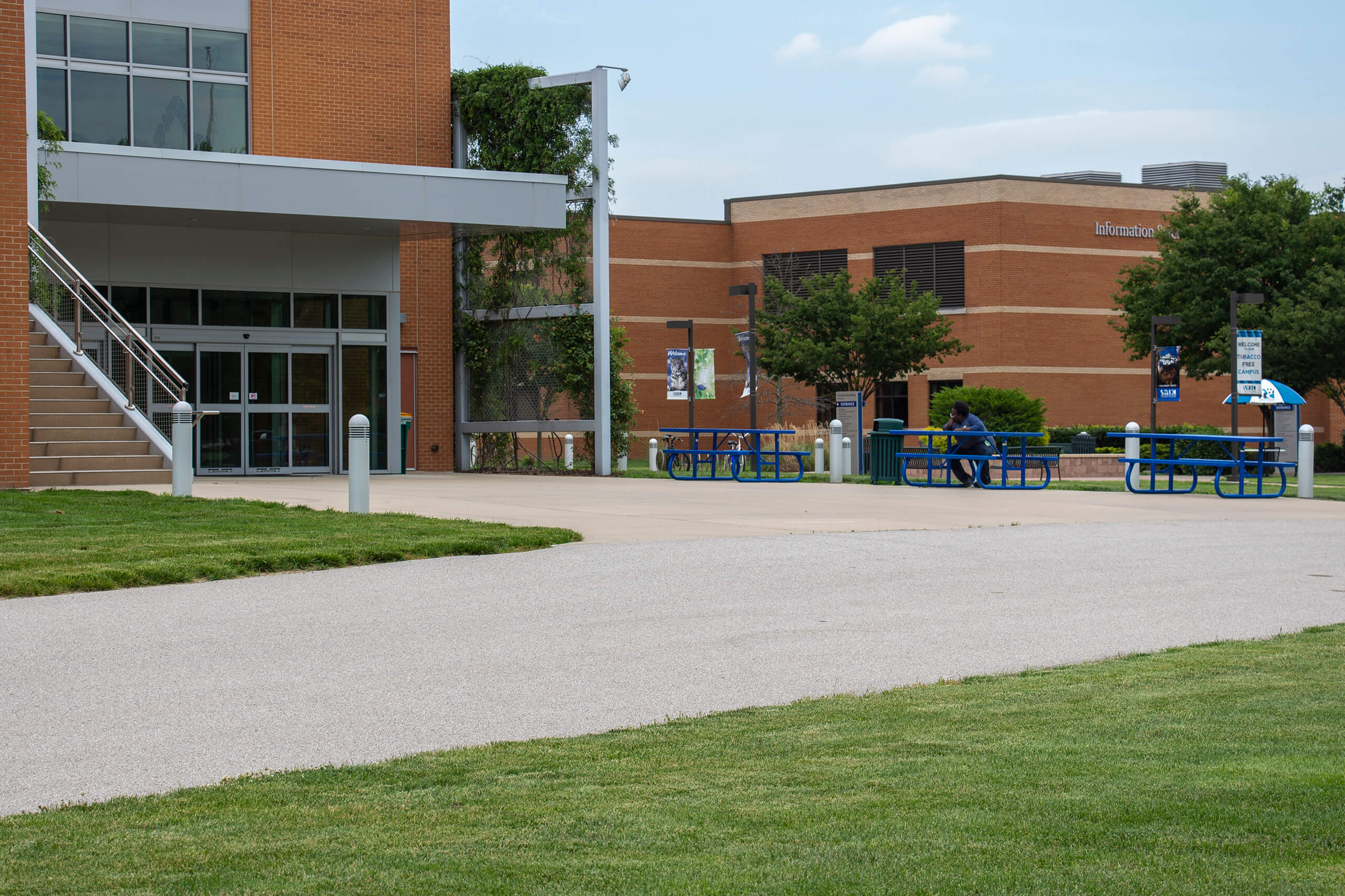 Photo of an African American male sitting in front of the Liberal Arts building.