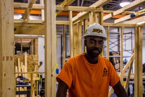 student looking at photographer in construction carpentry.