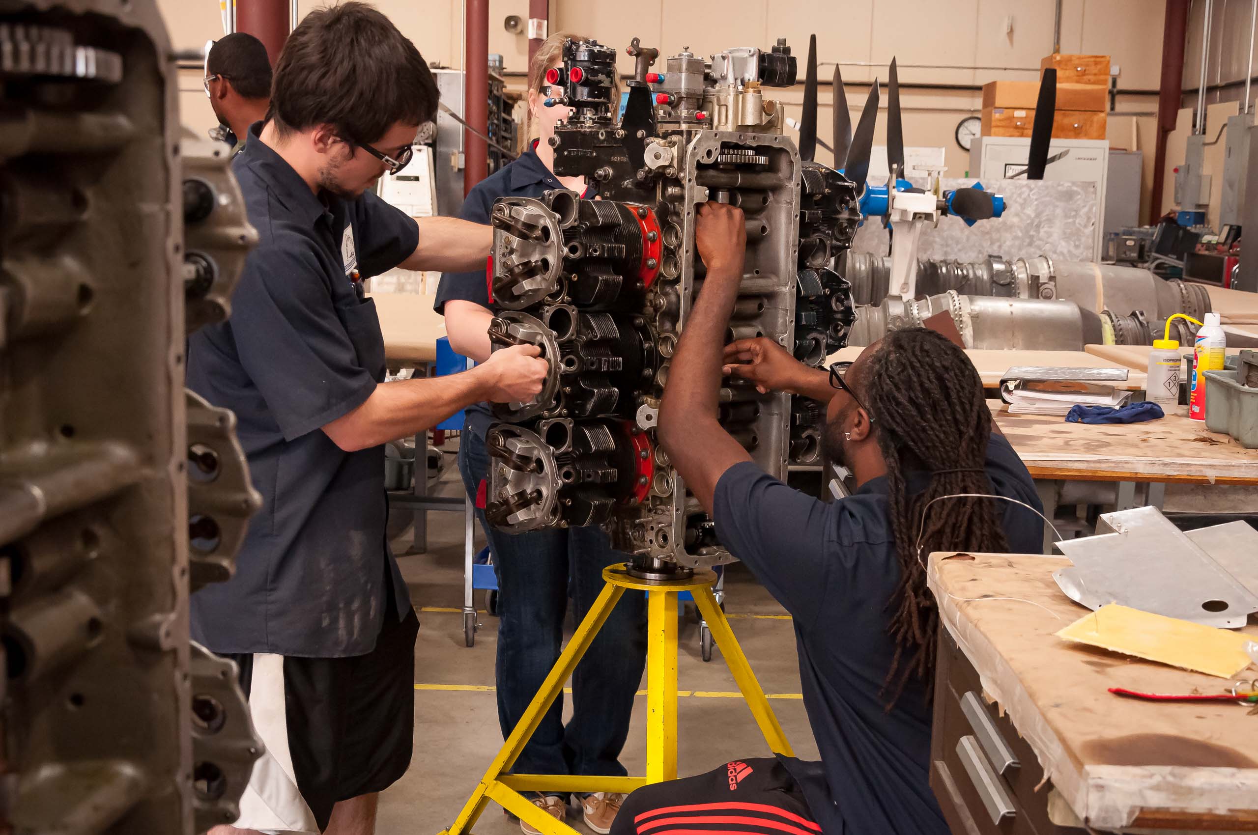 Aircraft Maintenance students working on engine.