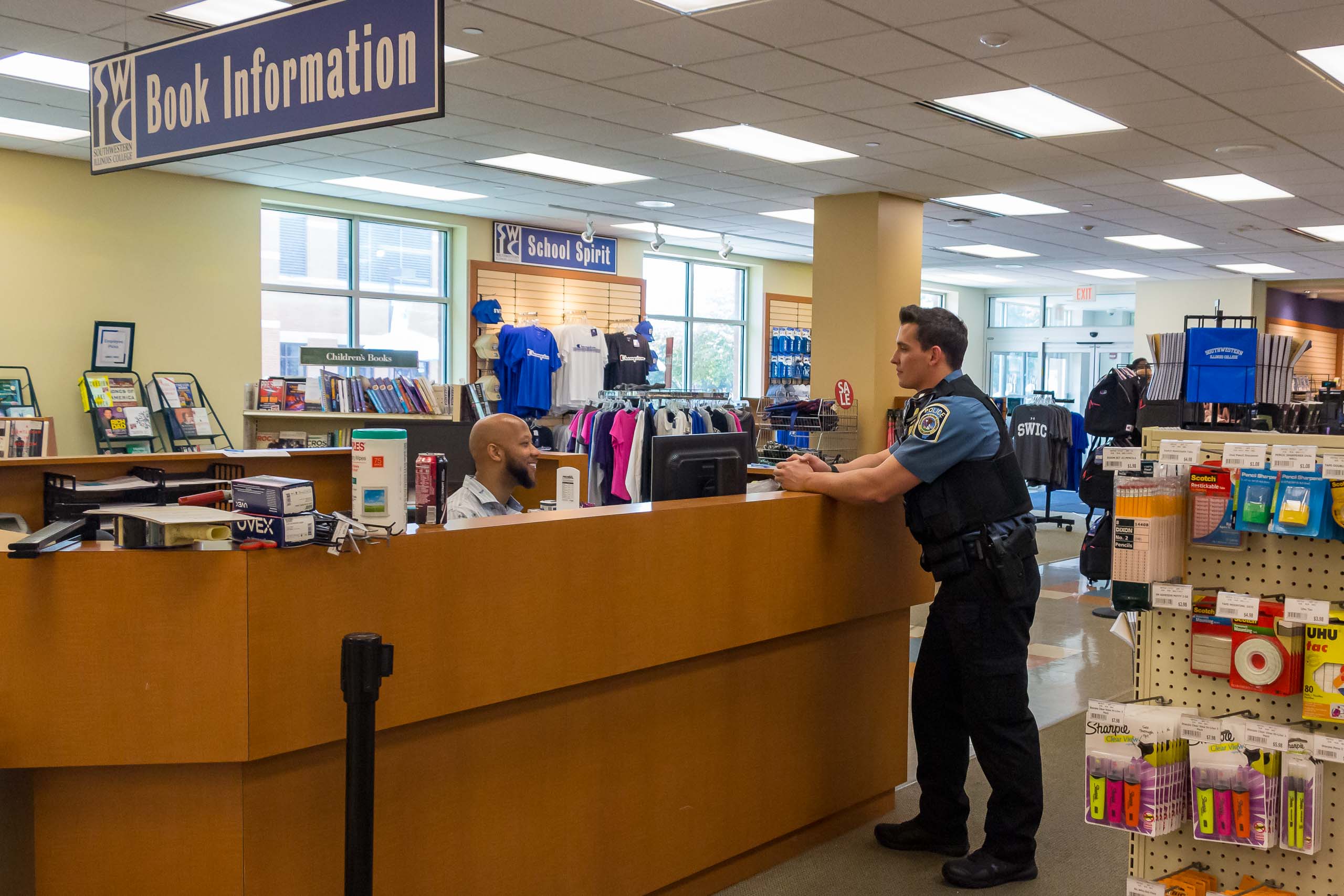 Officer speaking to Book Information attendant at SWIC Book Store.