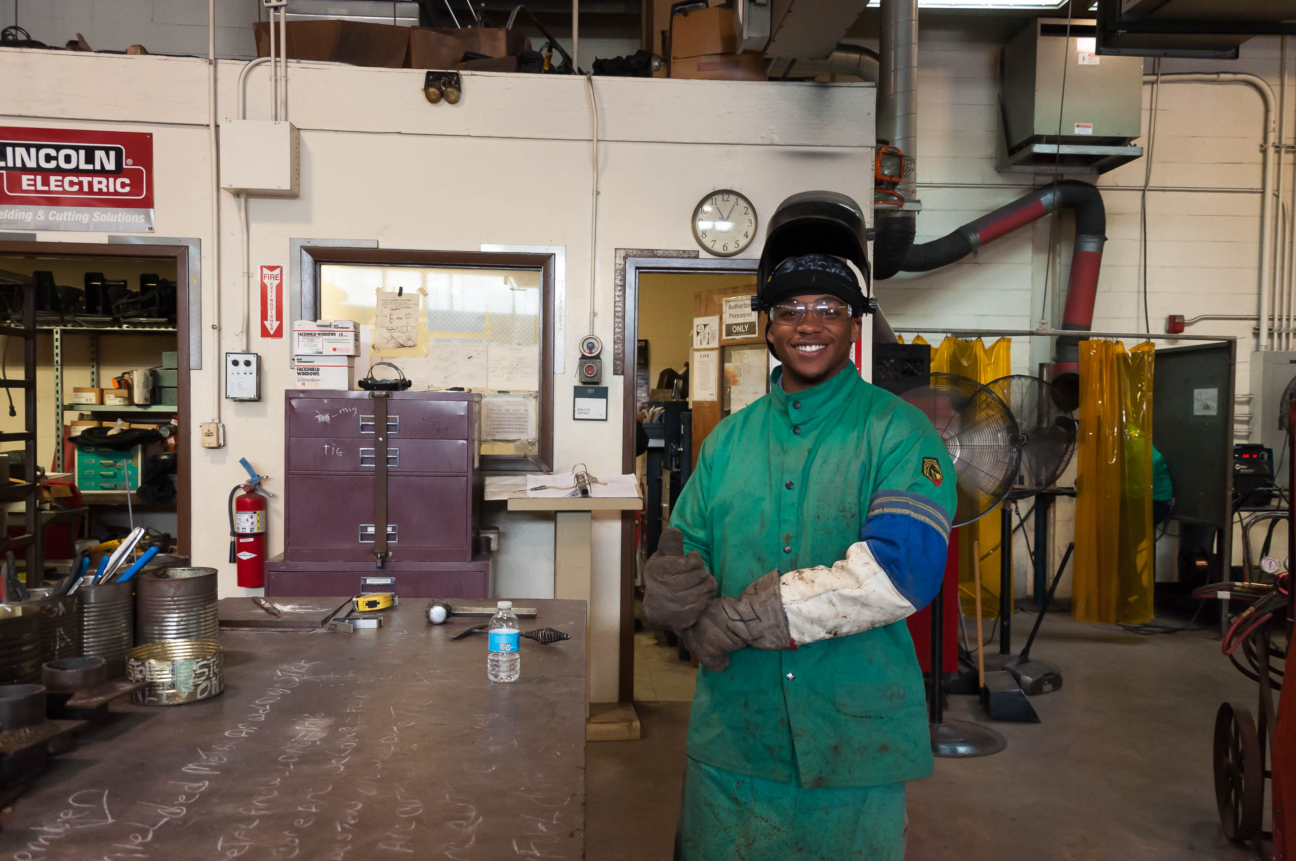 Student smiling in welding class.