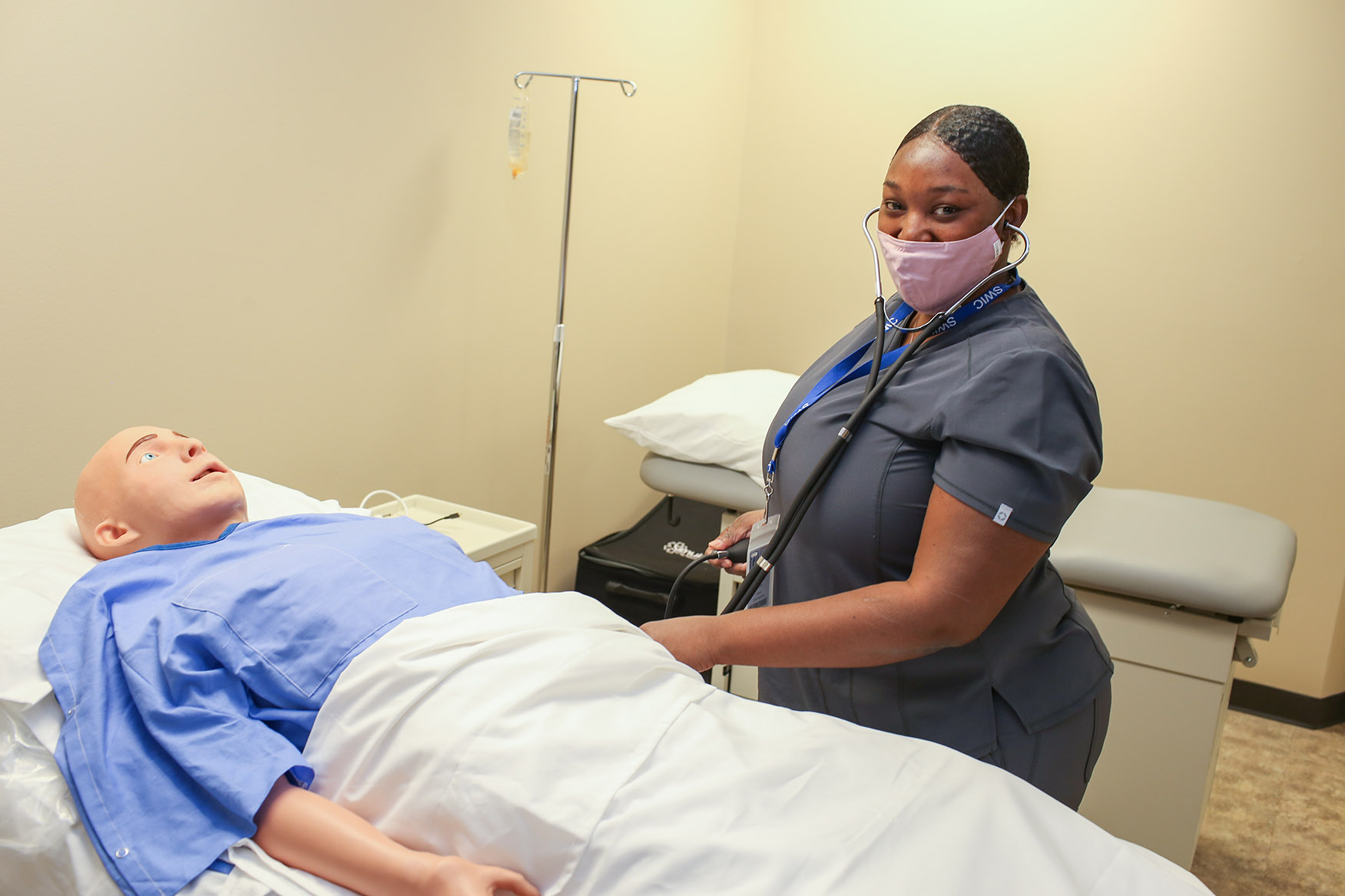 nursing student practices with medical dummy
