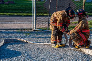 Hecker Fire Science training men using a hose