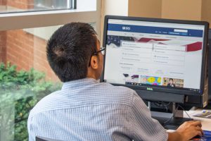 mt-4 Student filling out IRS forms in Financial Aid Office