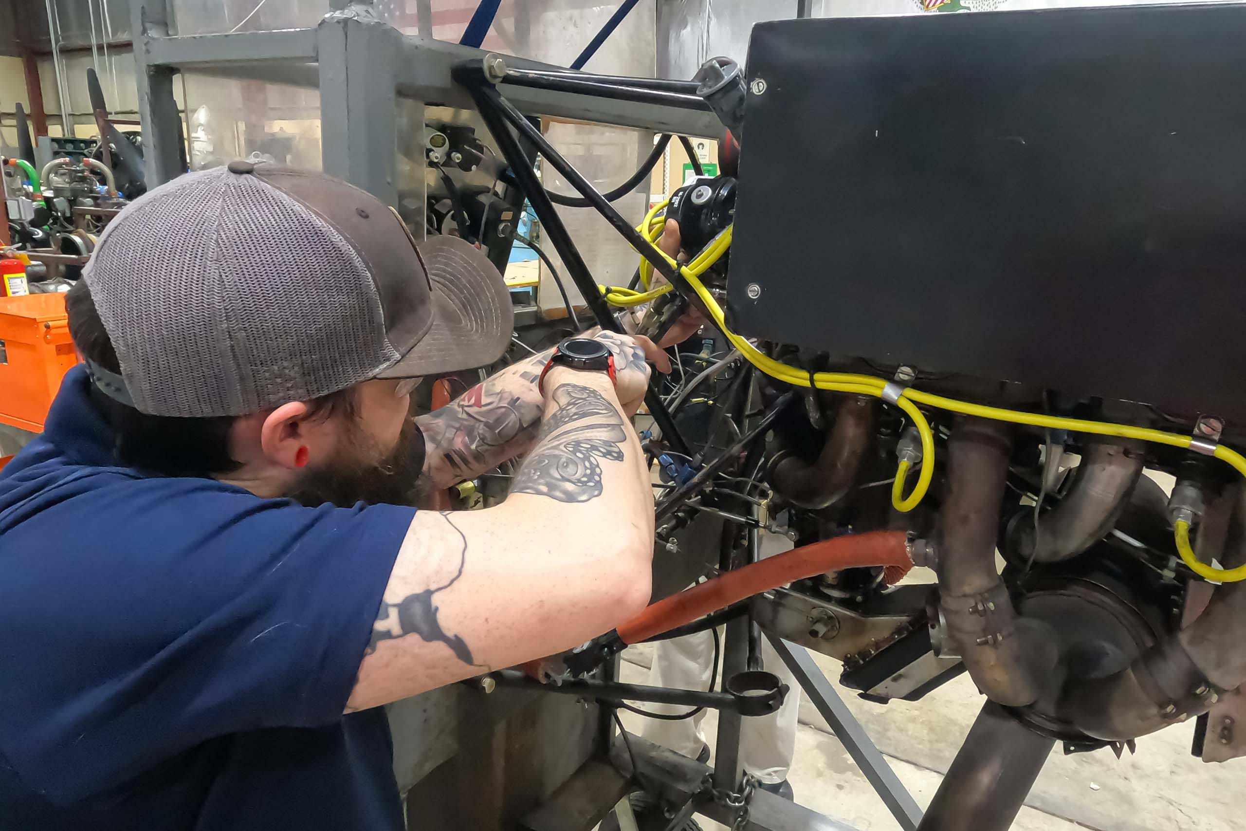 Aviation maintenance student fixing airplane part