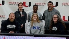 Girl signing on to Volleyball Team