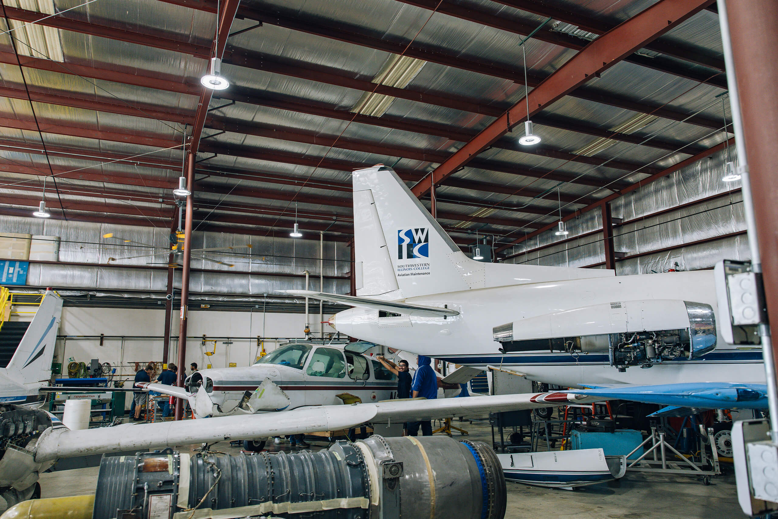 Airplanes in hangar for Aviation Degrees - maintenance, management, dispatcher or pilot.